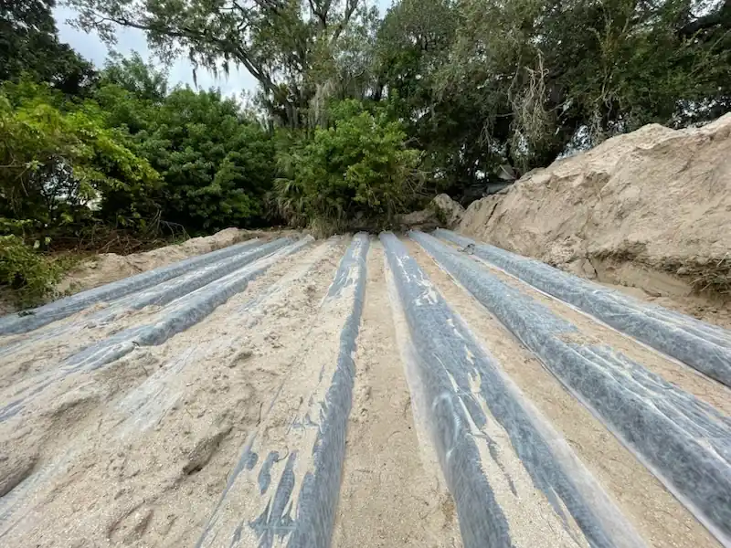 Close up view of parallel septic drain field lines ready for backfill