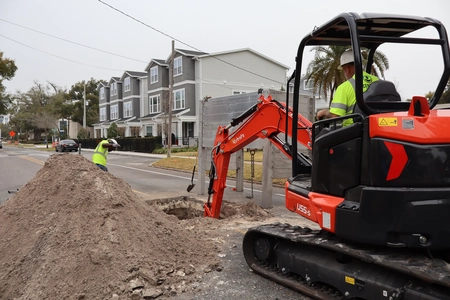 Excavator digging a drainage trench